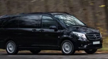 Large black VAN MERCEDES Vito on the road, exterior side view
